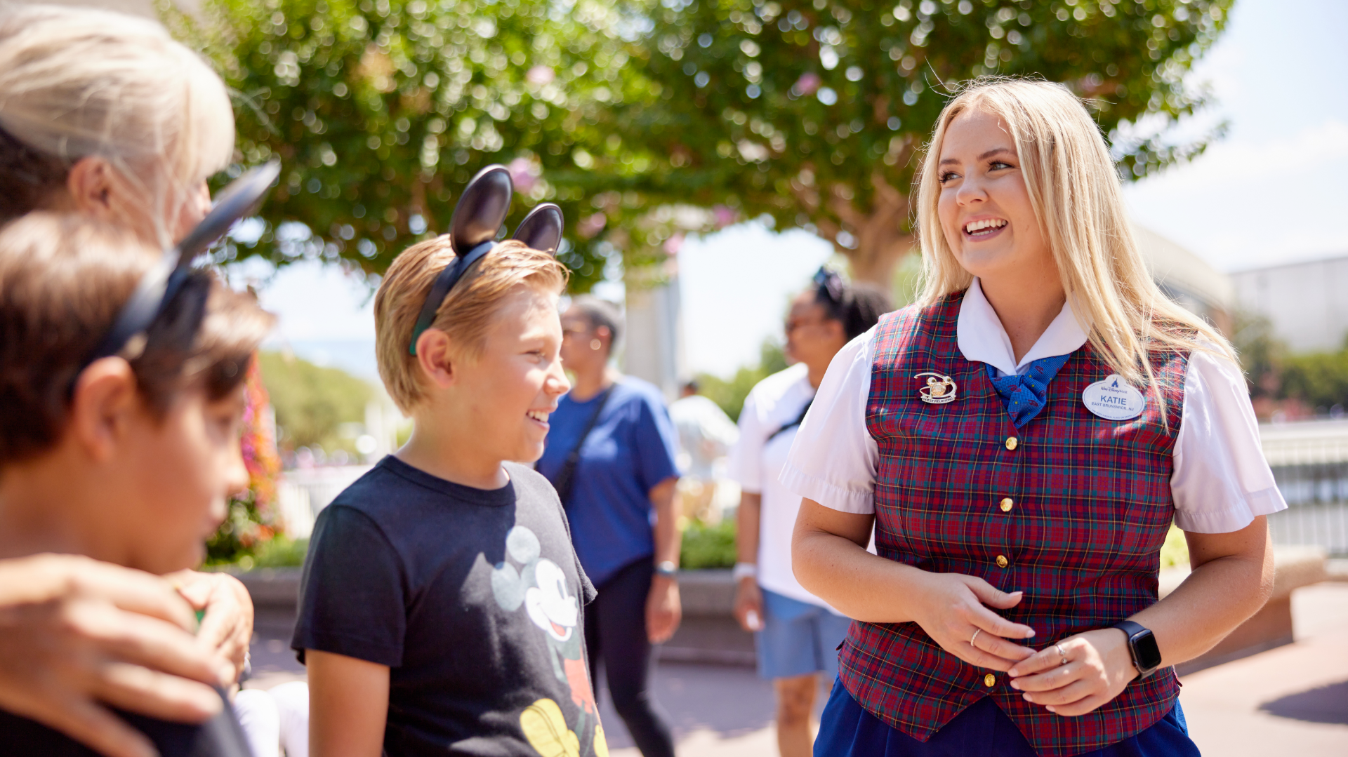 Disney Cast Member smiling while helping guests