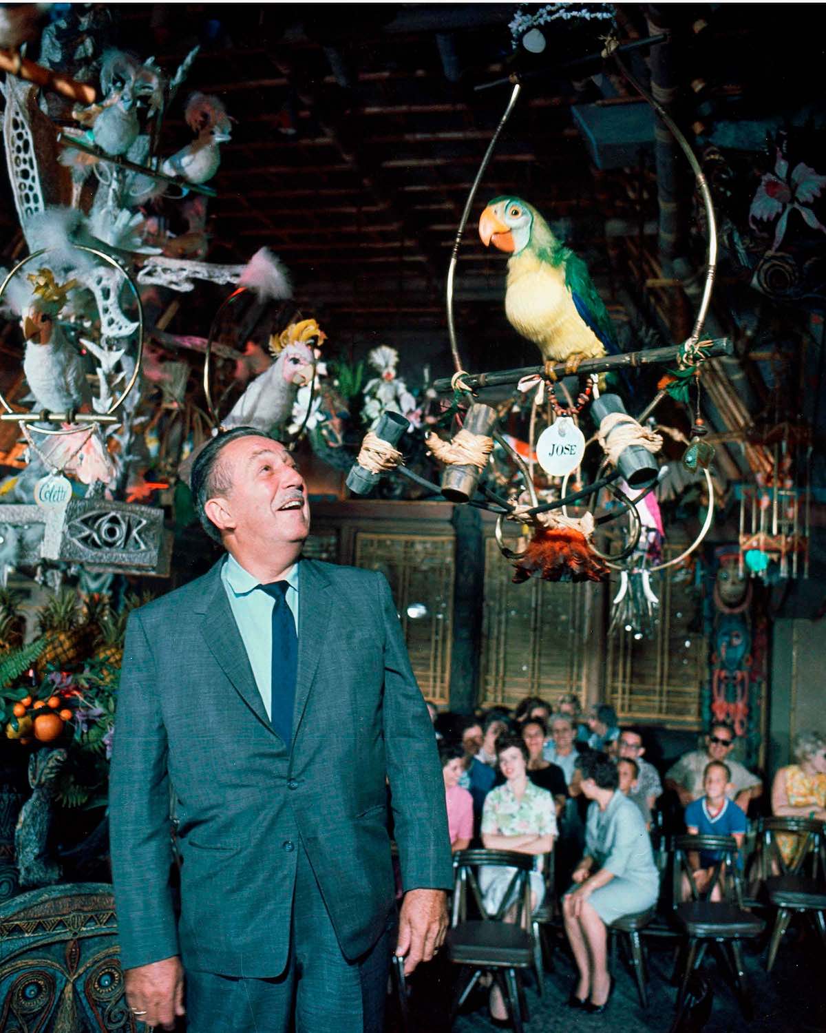 Walt Disney interacting with Audio-Animatronics birds at the Enchanted Tiki Room at Disneyland.