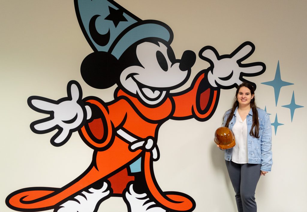 Disney Imagineer Mari Fontiveros stands in front of Mickey mural