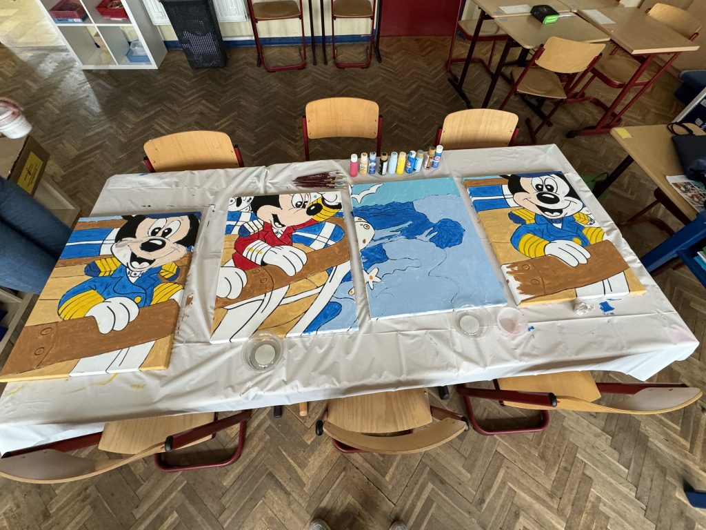 Four separate paintings that are pieces of one large painting of Captain Mickey and Captain Mickey.