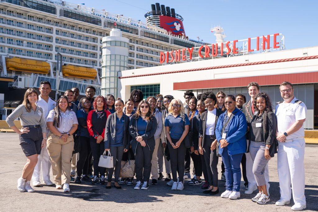 Disney Cruise Line career bound panel poses in front of cruise port