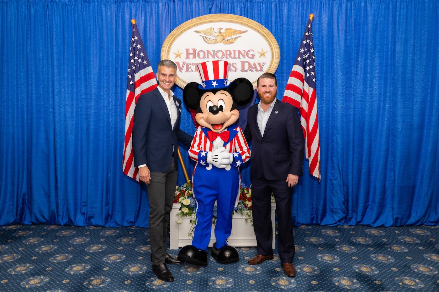 Disney Experiences Chairman Josh D’Amaro with Mickey Mouse and Student Veterans of America president and CEO Jared Lyon.