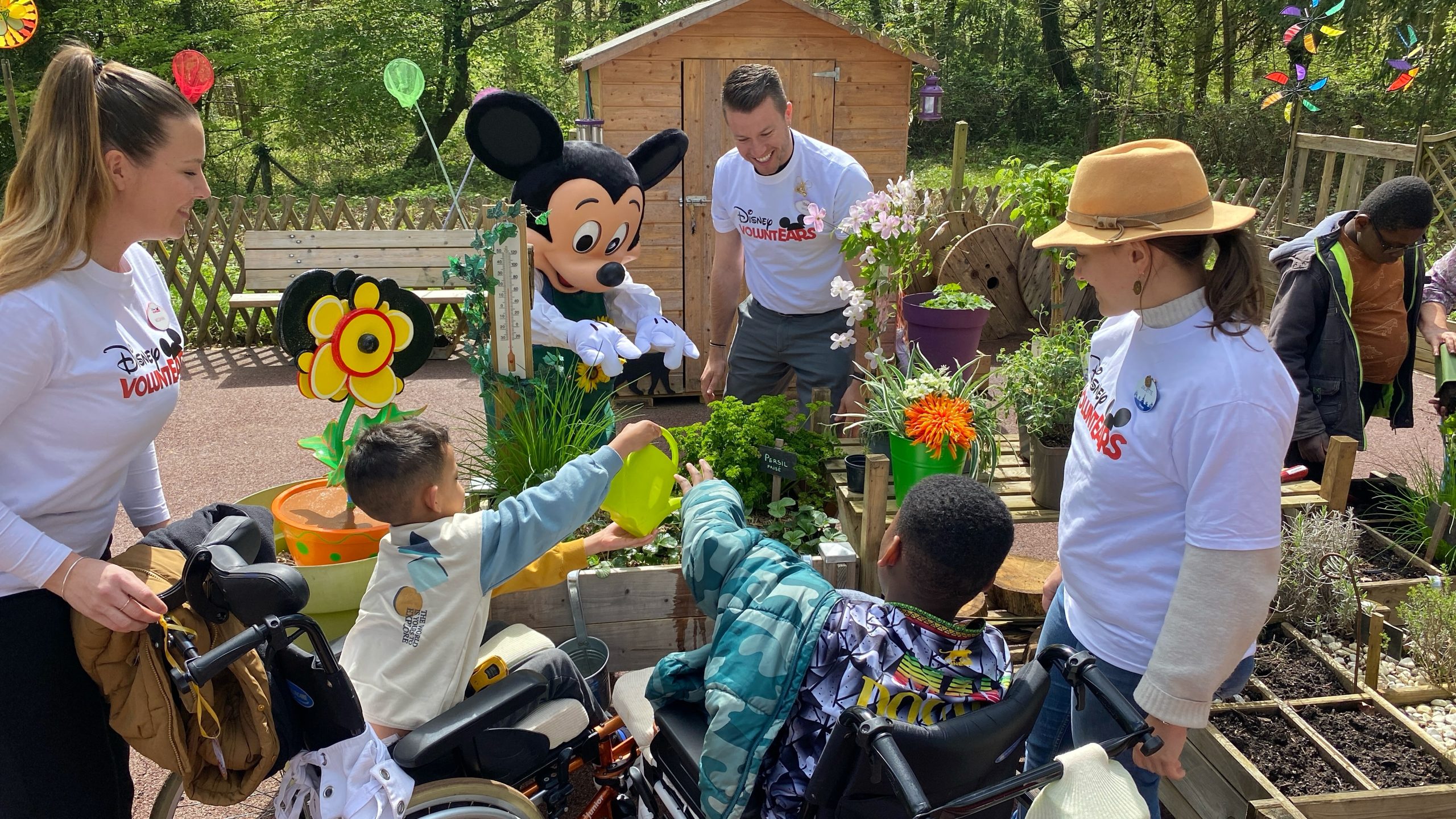 Mikcey Mouse and Disney VoluntEARS interact with the community