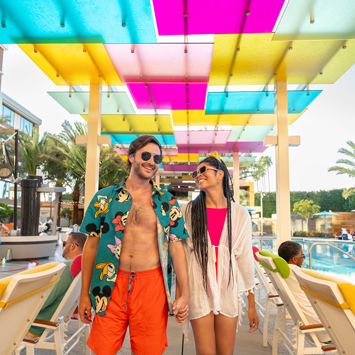 Couple walking by pool at the Villas at Disneyland Resort