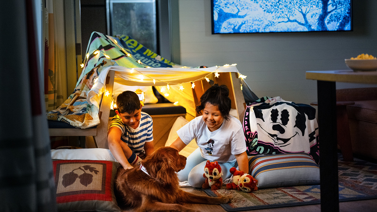 two kids and dog inside a Disney Vacation Club resort