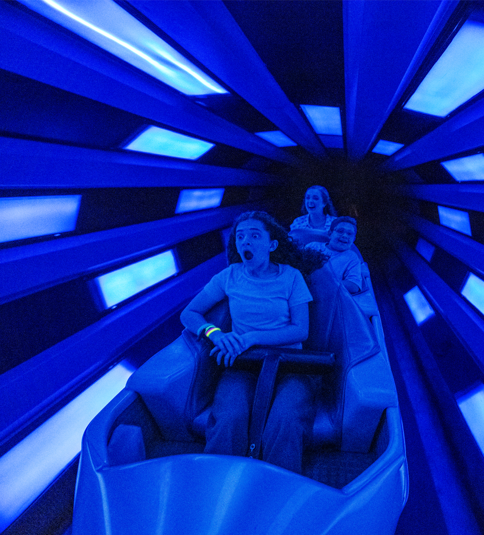 Guests riding Space Mountain at Magic Kingdom