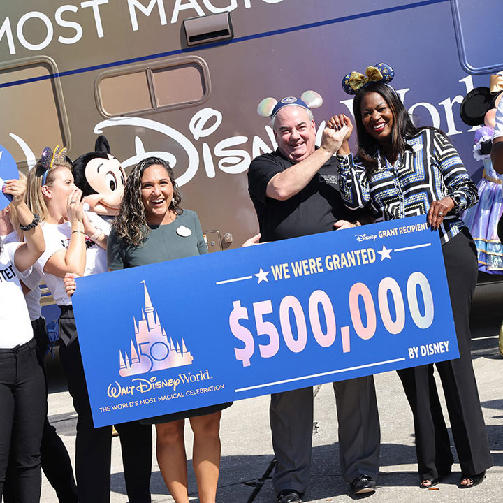 Disney Cast Members celebrate a Disney Grant presentation for the Heart of Florida United Way for Walt Disney World Resort’s 50th Anniversary