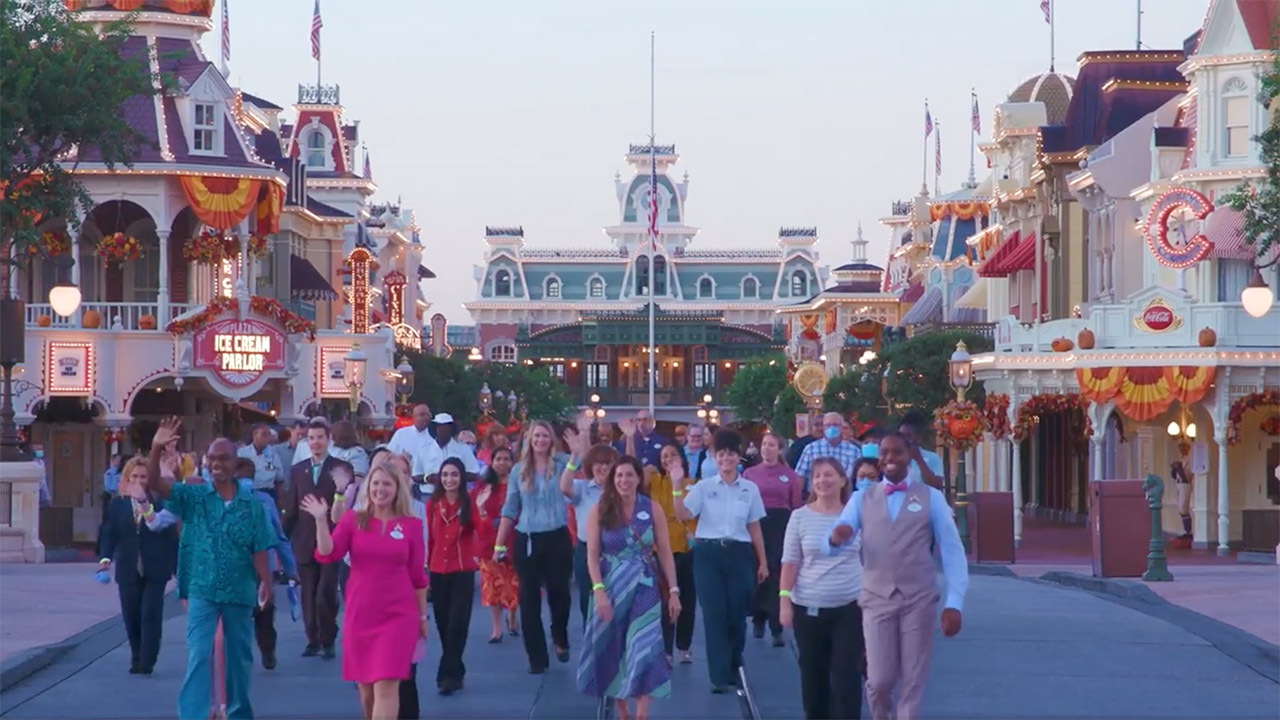 The 2022-2023 Walt Disney World Ambassador team lead Cast Members down Main Street, U.S.A. at Magic Kingdom Park