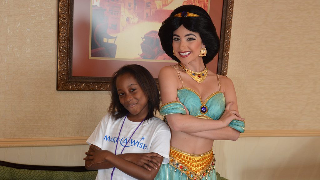 A child on a wish trip from Make-A-Wish interacts with Jasmine