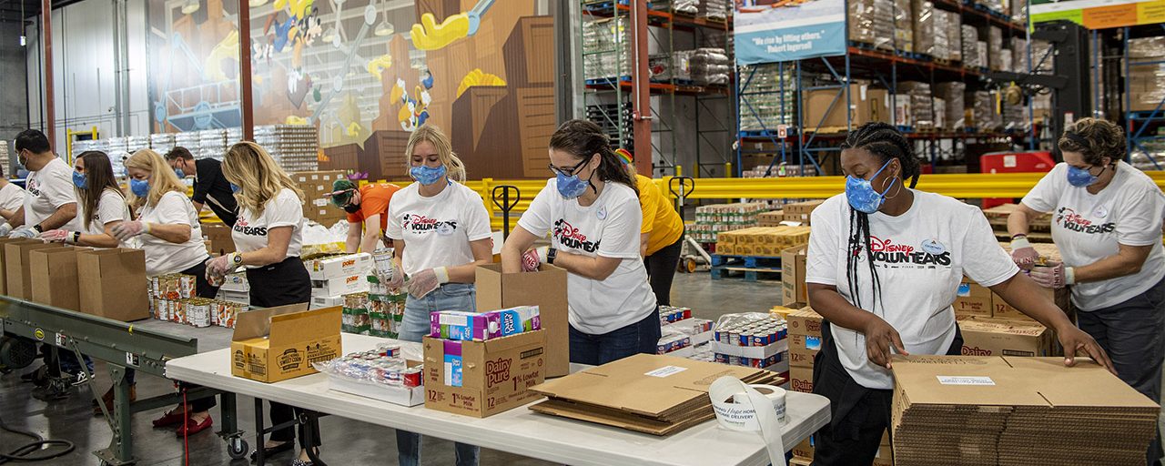 Disney VoluntEARS are seen packing food donation boxes inside the warehouse at Second Harvest Food Bank of Central Florida.