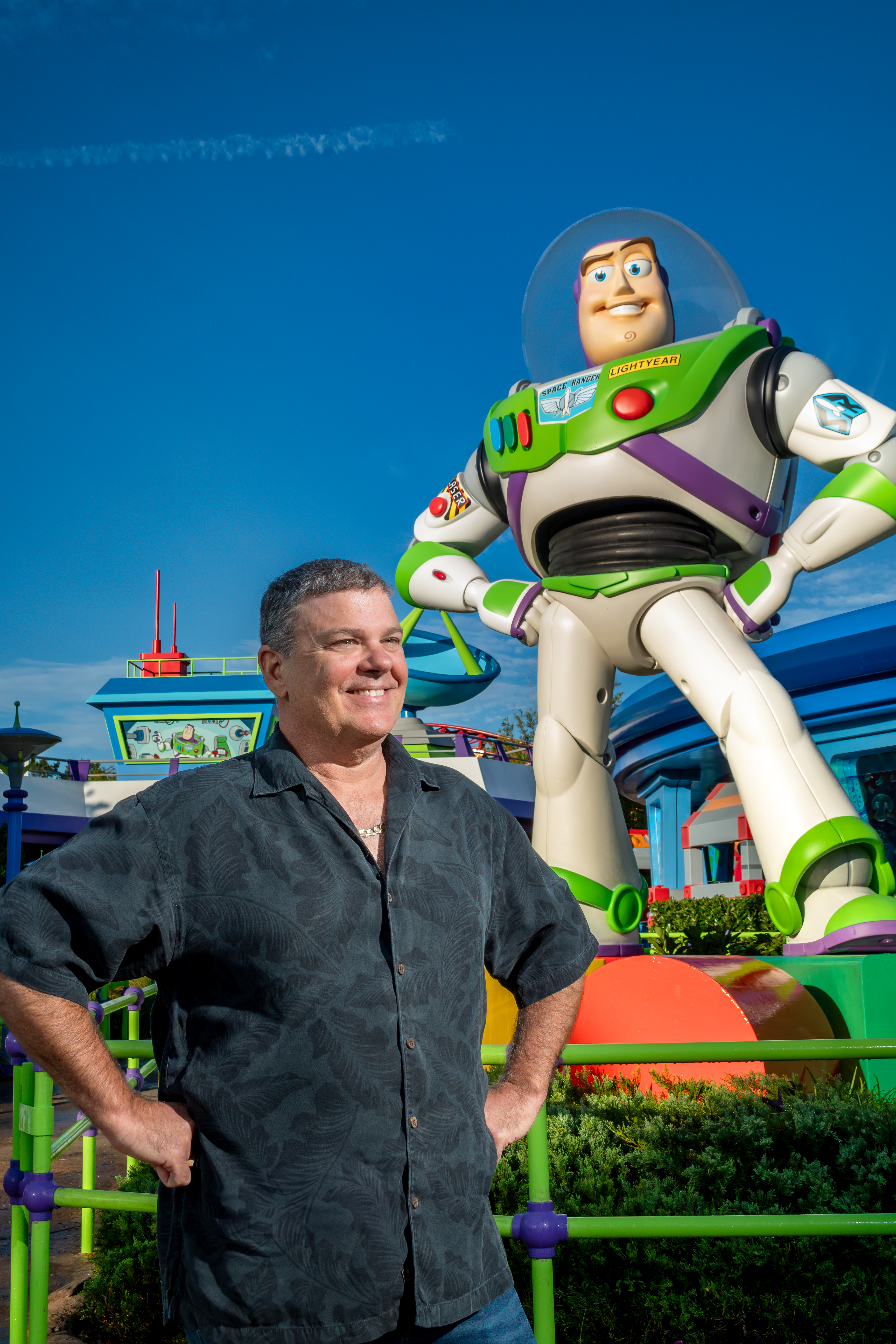 Drayton Knox, Owner of Icarus Exhibits stands under Buzz Lightyear statue in Toy Story Land at Disney’s Hollywood Studios.