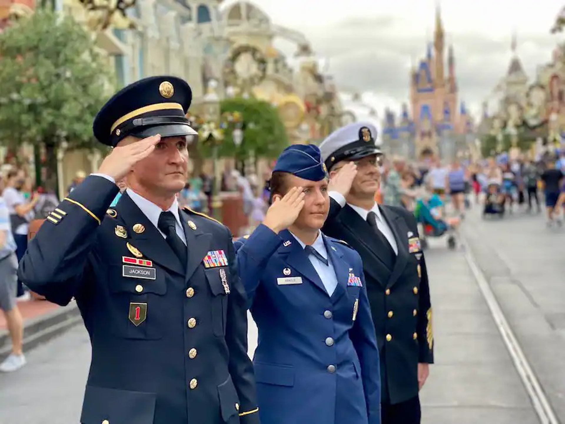 Service men and women saluting on Main Street U.S.A. at Disney’s Magic Kingdom Park.