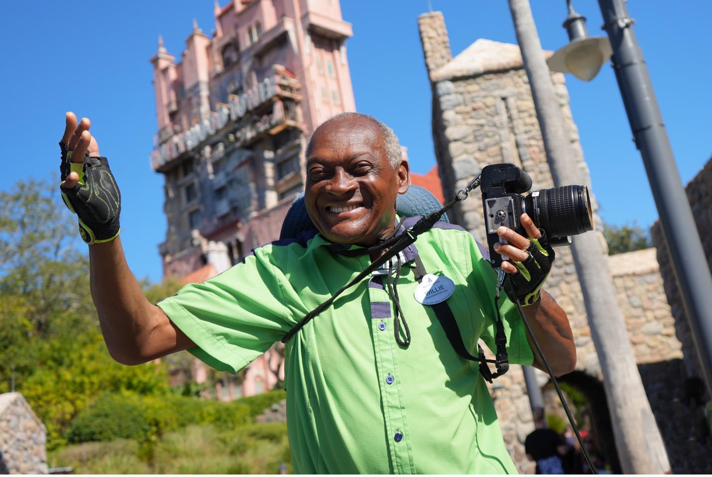 Disney PhotoPass cast member holding a camera at Disney's Hollywood Studios