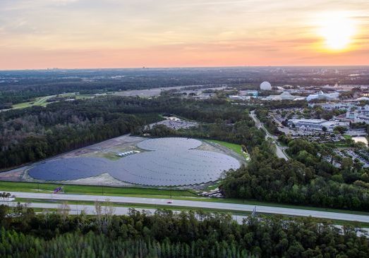 A landscape aerial image of a large Mickey Mouse-shaped solar array.
