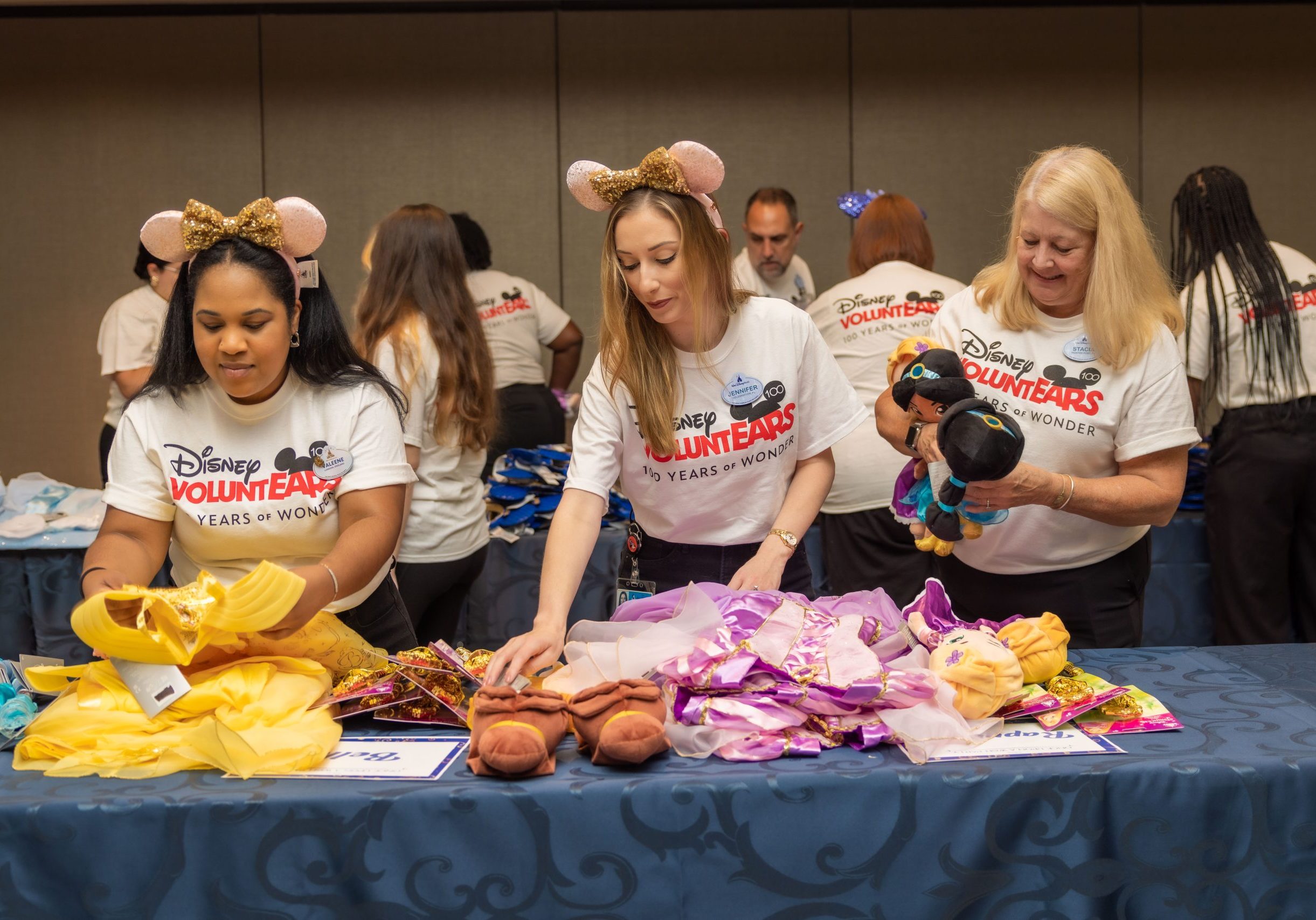 Volunteers sorting disney princess merchandise