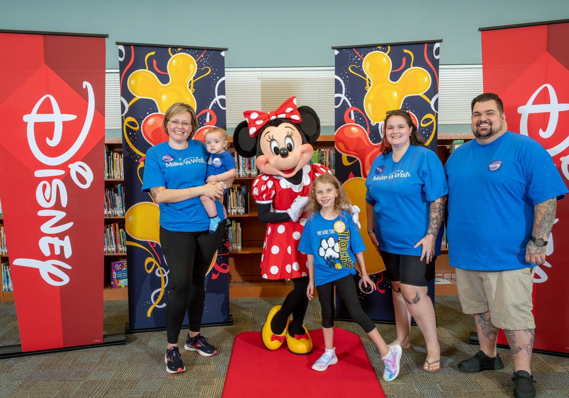 a group of people posing with minnie