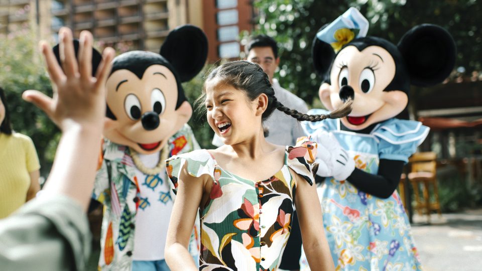 Mickey and Minnie dancing with girl at Aulani.