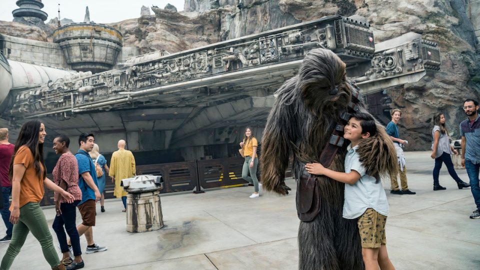 Boy hugging Chewbacca in Star Wars: Galaxy's Edge.
