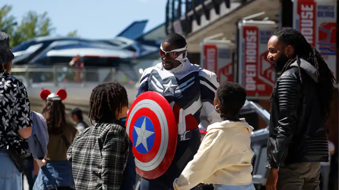 The new Captain America greets two boys and their dad at Avengers Campus in Disneyland Paris.