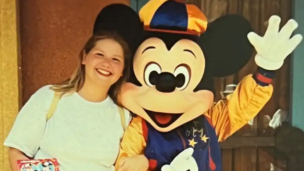 A photo of Donna meeting Mickey Mouse when she was younger. 