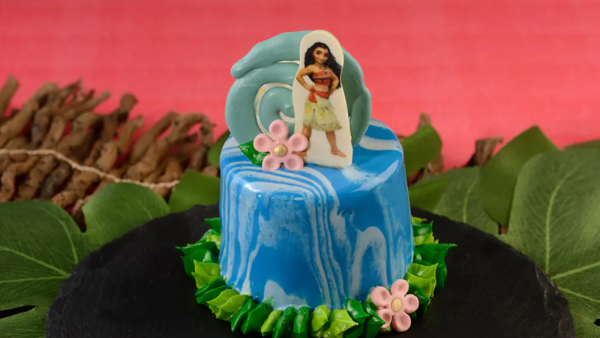Moana themed cake with a waterfall base and picture of her on top. 