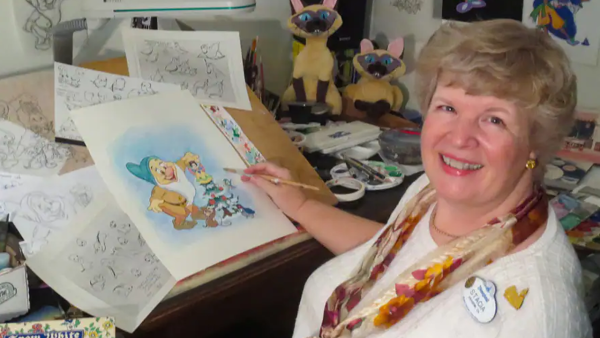 Disney Artist and Historian Stacia Martin posting at her animator's desk. 