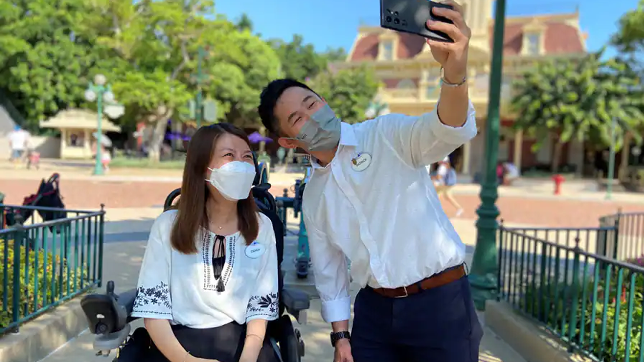 Cast Members take a selfie in front of the Castle. 