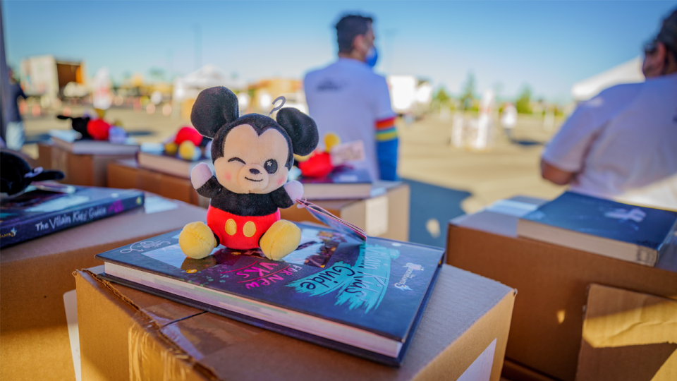 Mickey plush sitting on top of a book.