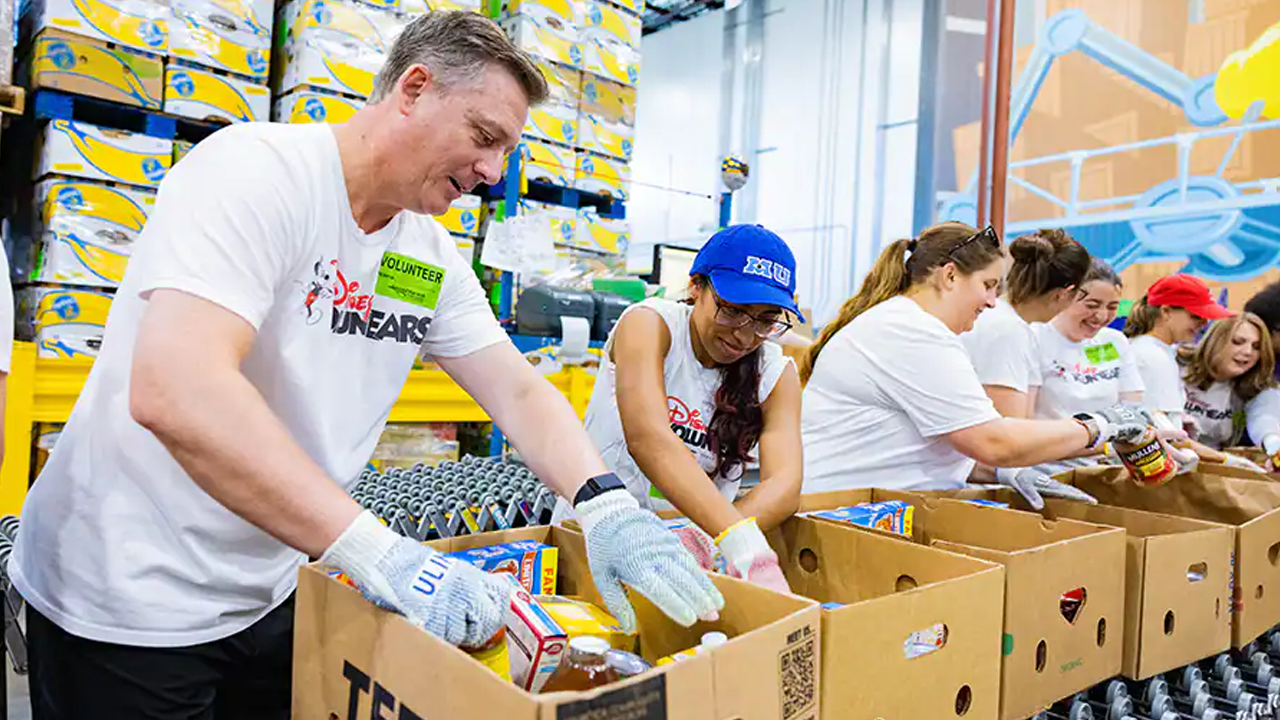 Disney VoluntEARS boxing up food donations.