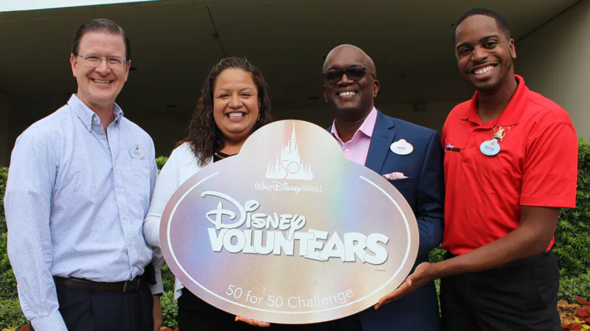 Four Leaders posing with Disney VoluntEARS sign.