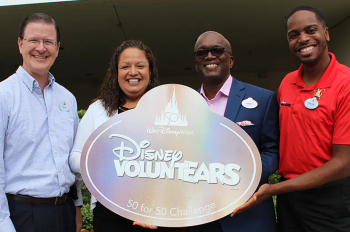 Four Leaders posing with Disney VoluntEARS sign.