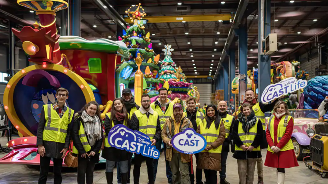 Disney Cast Members tour the Holiday Warehouse wearing safety vests and posing for a picture.