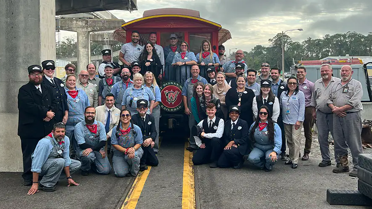 Disney Cast Members working the train post for a pic with the caboose.. 