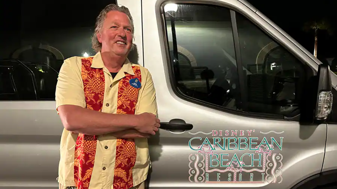 Ken standing in front of a Disney's Caribbean Beach van.