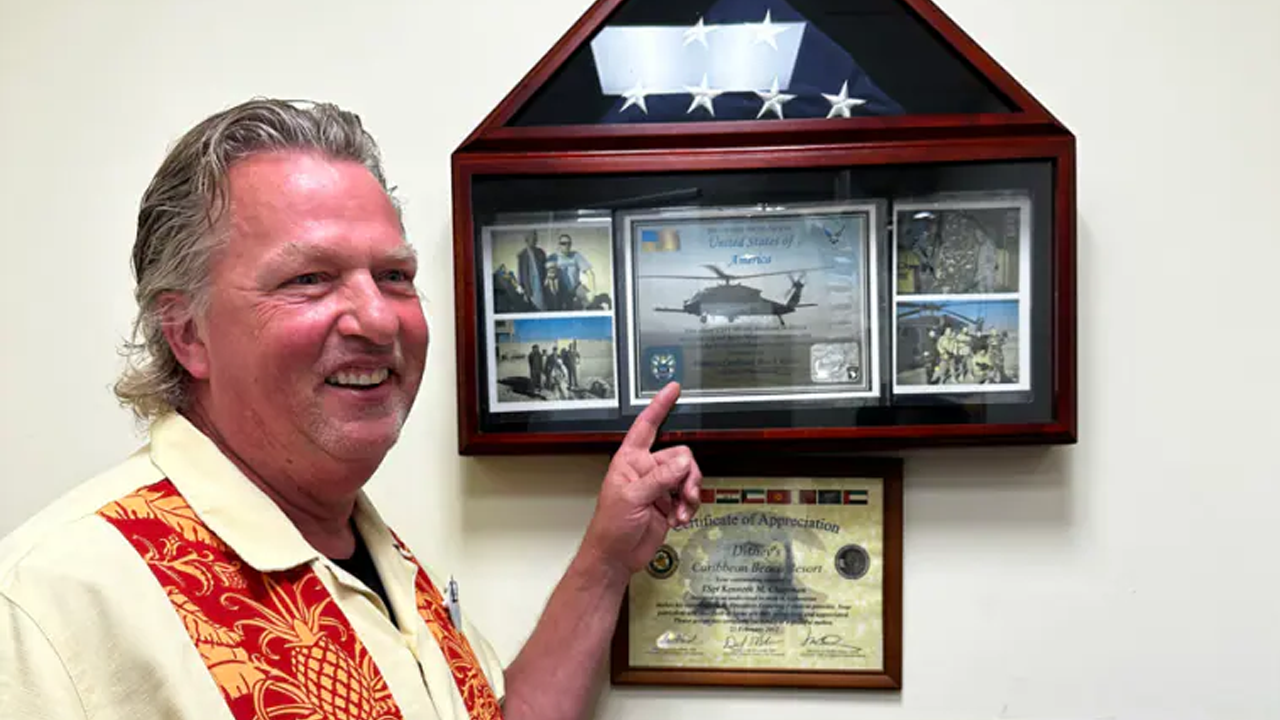 Ken showing off his awards. 