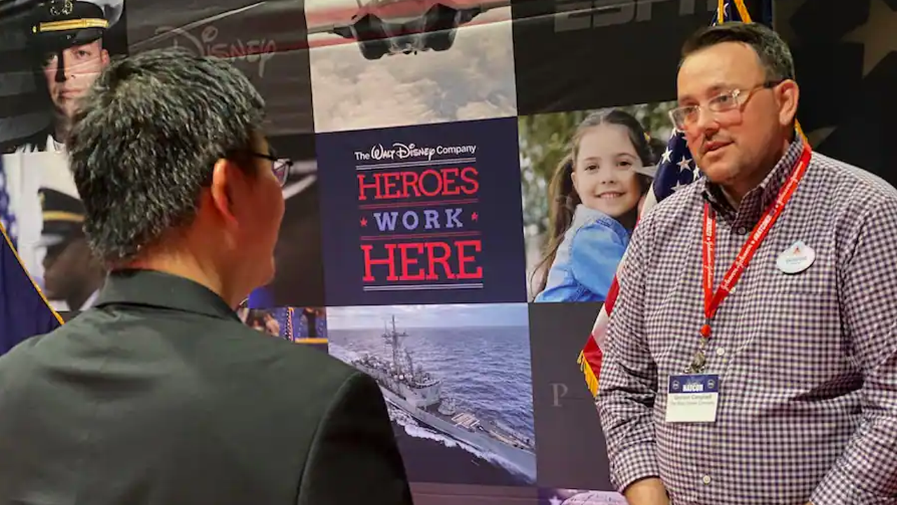 Disney cast member Gordon Campbell chats with an attendee of the 2023 Student Veterans of America National Conference at Walt Disney World Resort