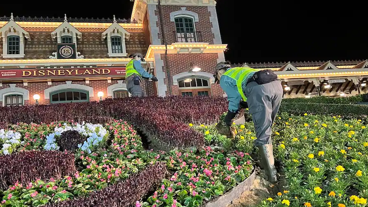 Cast Members working on a flower bed. 