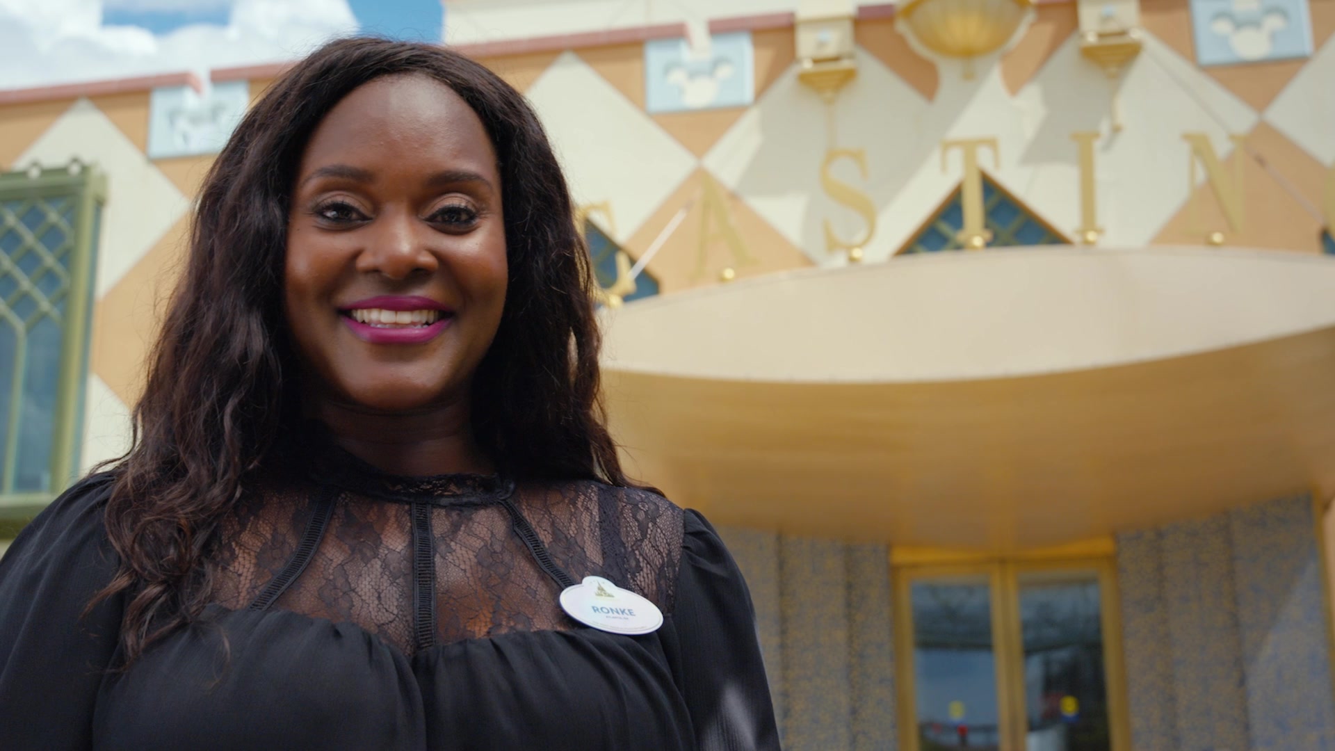 Ronke standing outside of the Casting building.