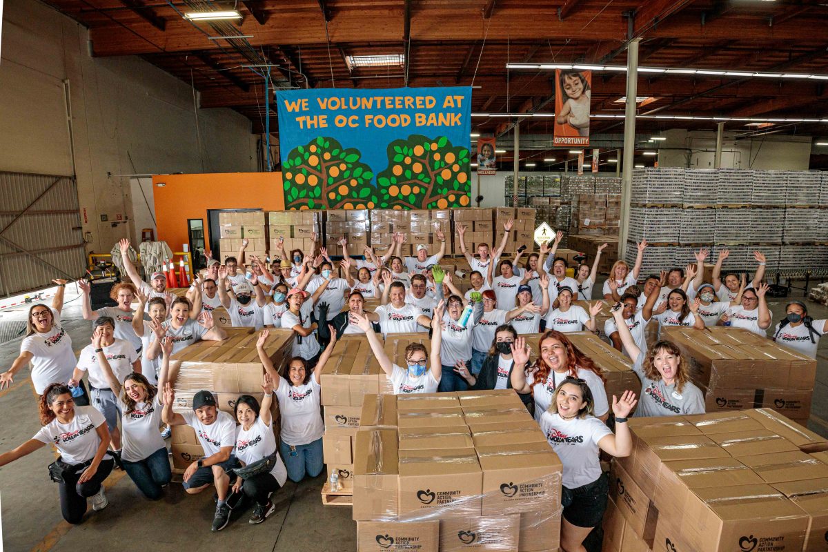 group of volunteers in front of a food bank banner