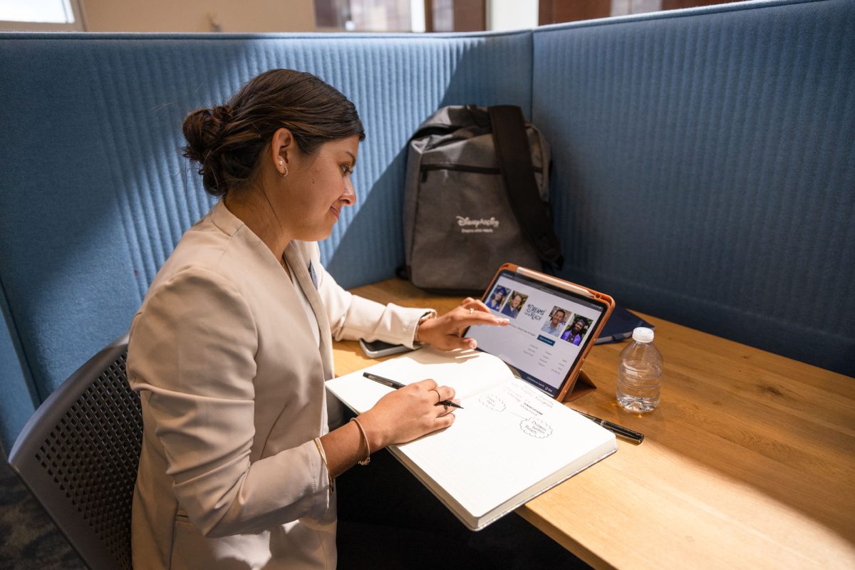 This picture depicts a professional woman at a desk visually mapping out her future via the Disney Aspire program.