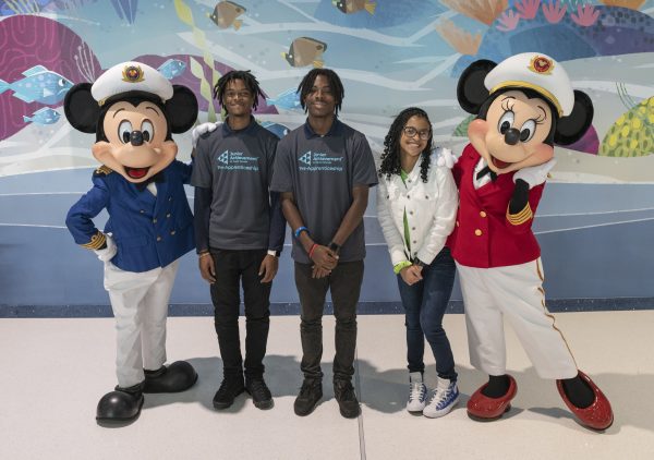 members of Boyd and Girls Club stand with Mickey and Minnie Mouse