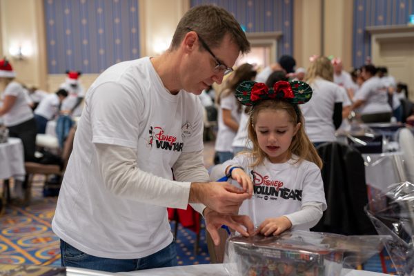 Disney VoluntEAR donates toys with his family