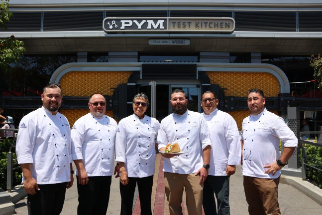 The food and beverage team, including Chef Montoya, show off their newest creation, the Humongous Taco Salad at Pym Test Kitchen in Avengers Campus.