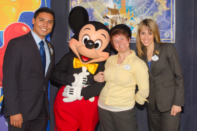 Former Disney cast member Michelle Fletcher celebrating her career at The Walt Disney Company with Mickey Mouse and former Disney Ambassadors René Torrico and Jolie Hales.