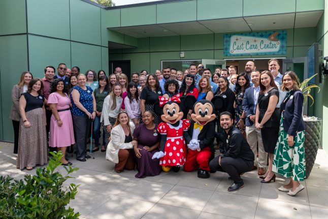 Cast Care Leaders smile in front of new Cast Care Center.  