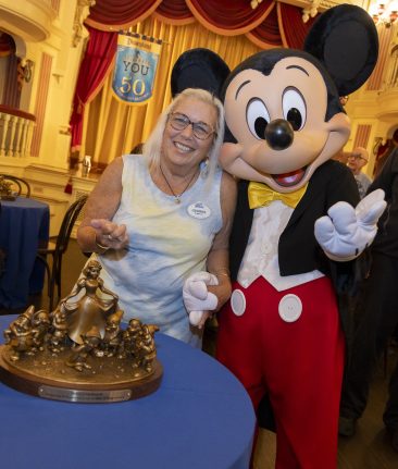 50-year Service Award recipient Debby 'Gehrke' McDowell with Mickey Mouse at the recent Service Celebration. 