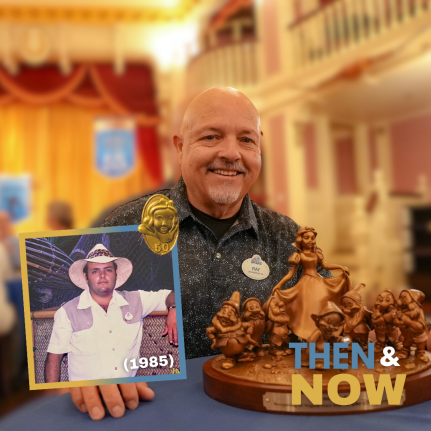 Ray Gill poses at the Service Celebration with his 50-year award, a Snow White bronze statuette. 