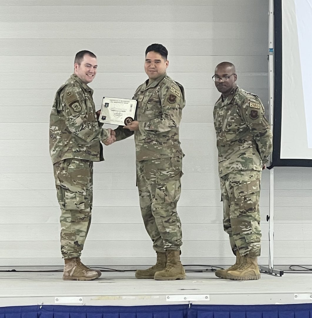 Disneyland Resort cast member Juan, receiving a Master Technician award by his lieutenant colonel.