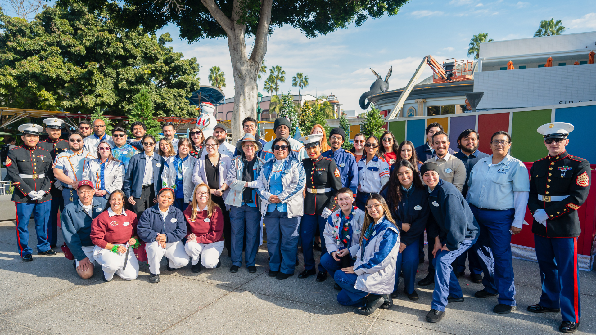  Tomorrowland cast members join together for a group photo with U.S. Marines after dropping off donated toys at the Toys for Tots donation bin in Downtown Disney District. 