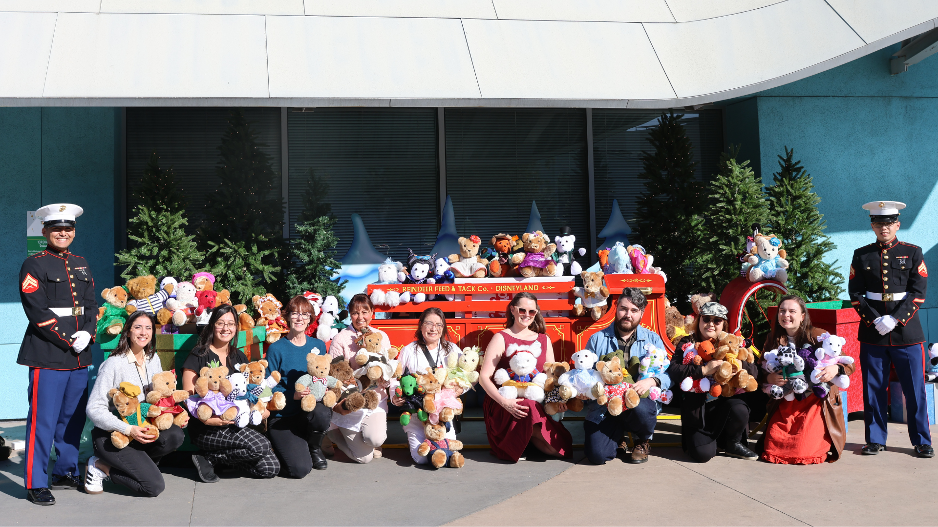 Cast members in the Costuming department with handmade bears their team created in donation to Toys for Tots. Each bear was crafted from costumes with repurposed fabric to create new one-of-a-kind toys made with care for kids in need.